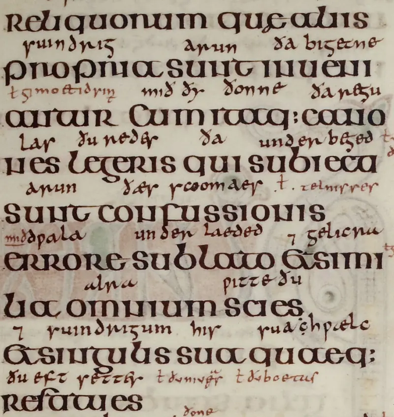 Broad Latin lettering with smaller Old English glosses between the lines in the Lindisfarne Gospels.